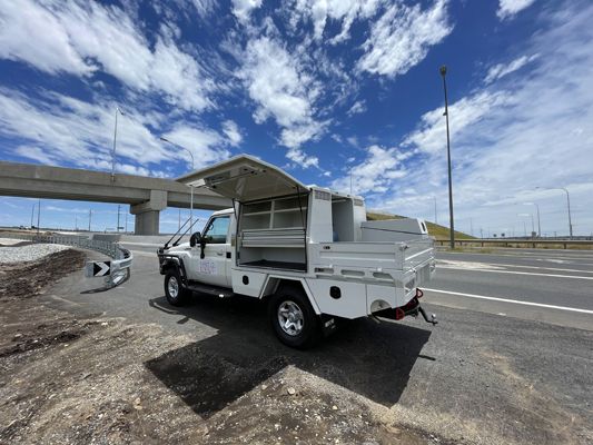 A white truck is parked on the side of the road.