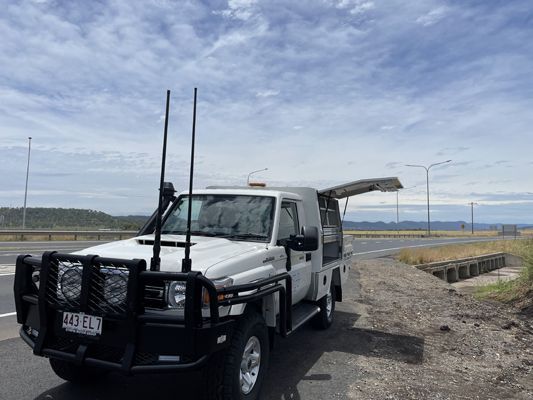 A white truck is parked on the side of the road.