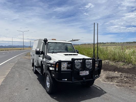 A white truck is parked on the side of the road.