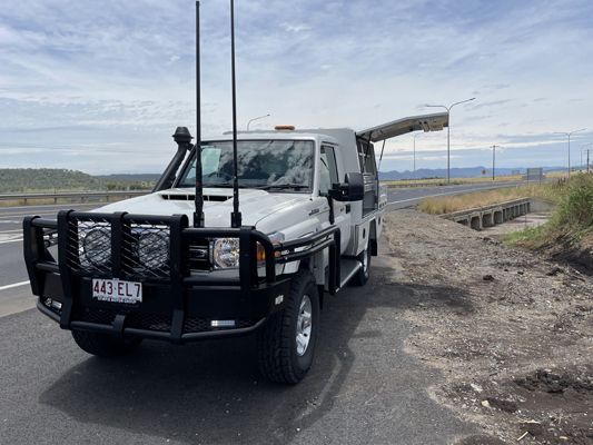 A white truck is parked on the side of the road.