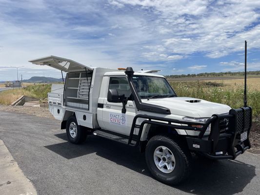 A white truck is parked on the side of the road.