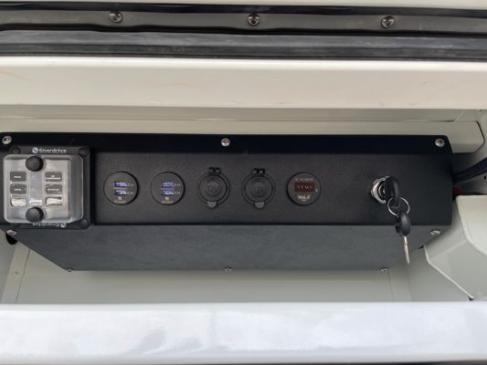 A black box with a bunch of buttons and a key on it.