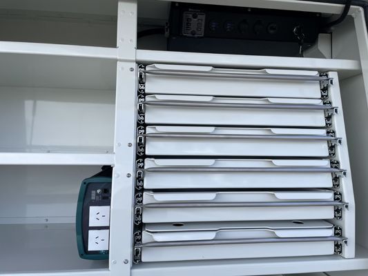 A shelf with drawers and electrical outlets on it