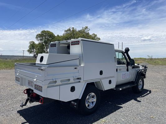 A white truck is parked on the side of the road.