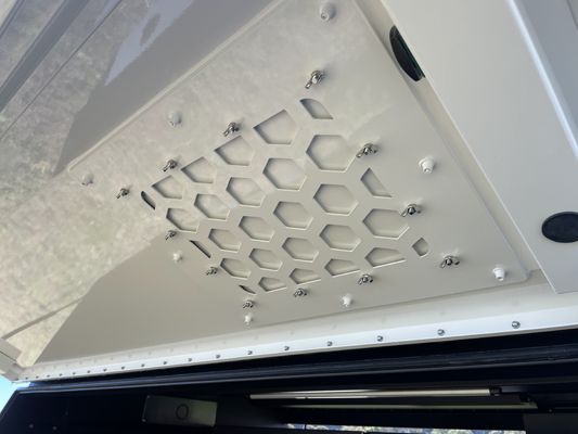 A close up of a ceiling with holes in it