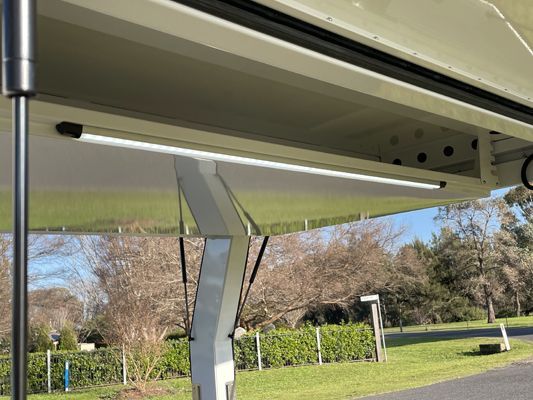 A light is hanging from the ceiling of a vehicle.