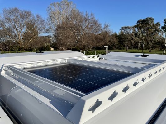 A white roof with a solar panel on it