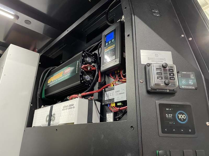 A close up of a box with a lot of wires coming out of it.