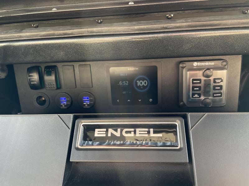 A close up of the dashboard of a vehicle with a engel logo on it.