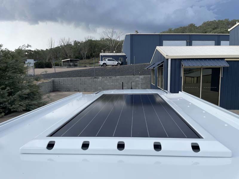 A large solar panel is on the roof of a building