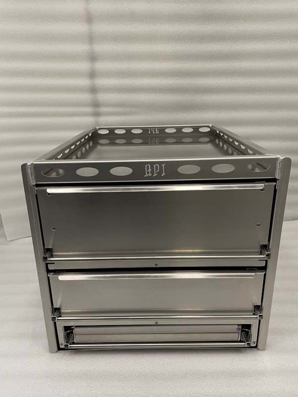 A stainless steel cabinet with two drawers is sitting on a white surface.