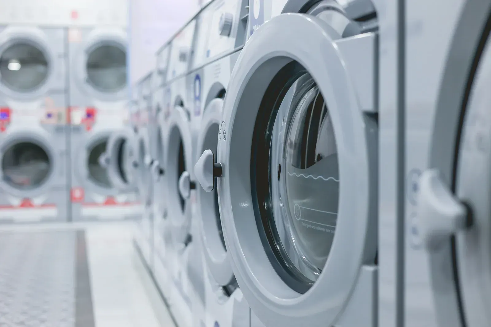 A row of washing machines in a laundromat.