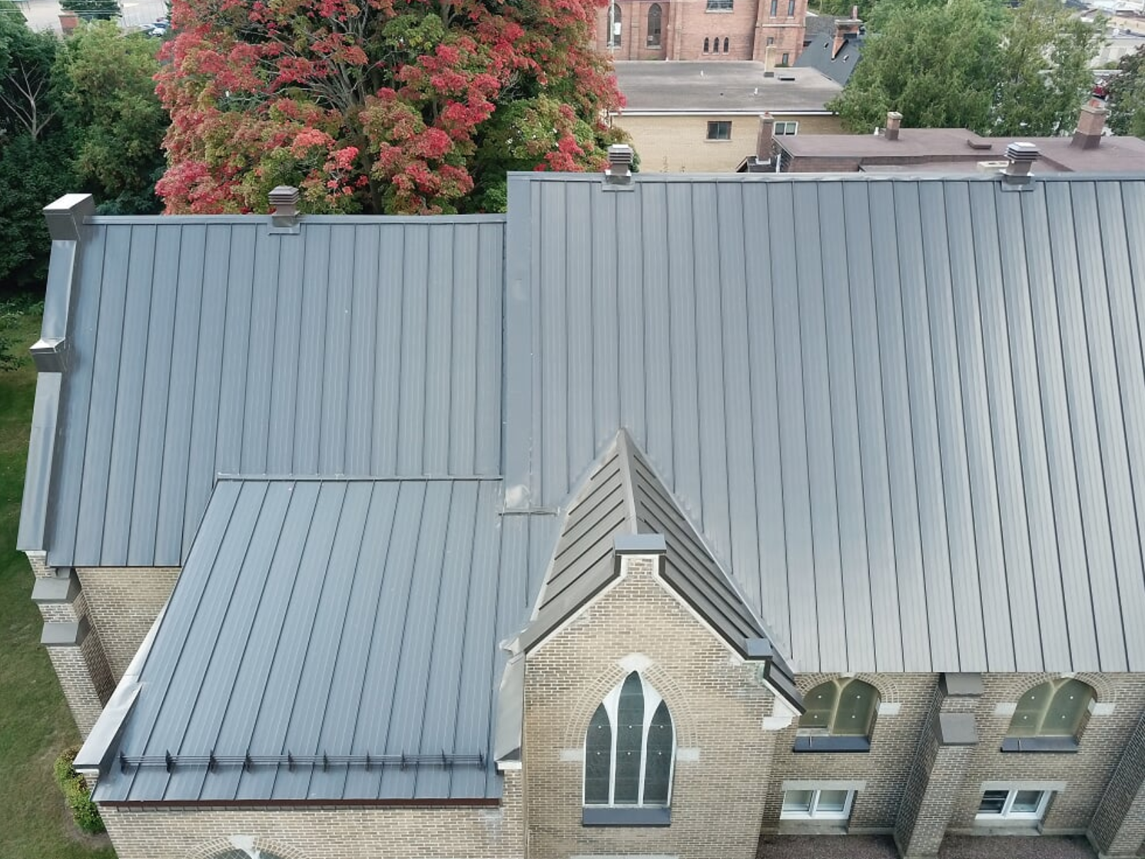 grey brick building with metal roofing