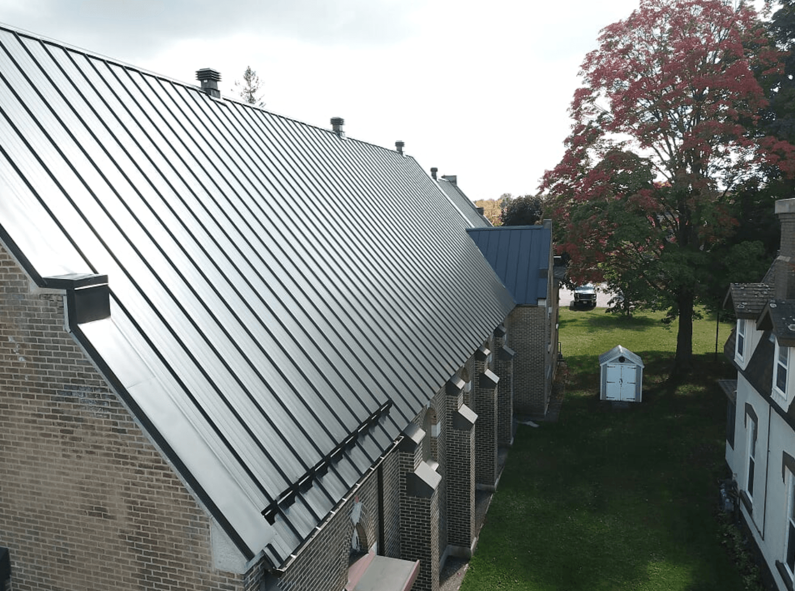grey brick building with metal roofing