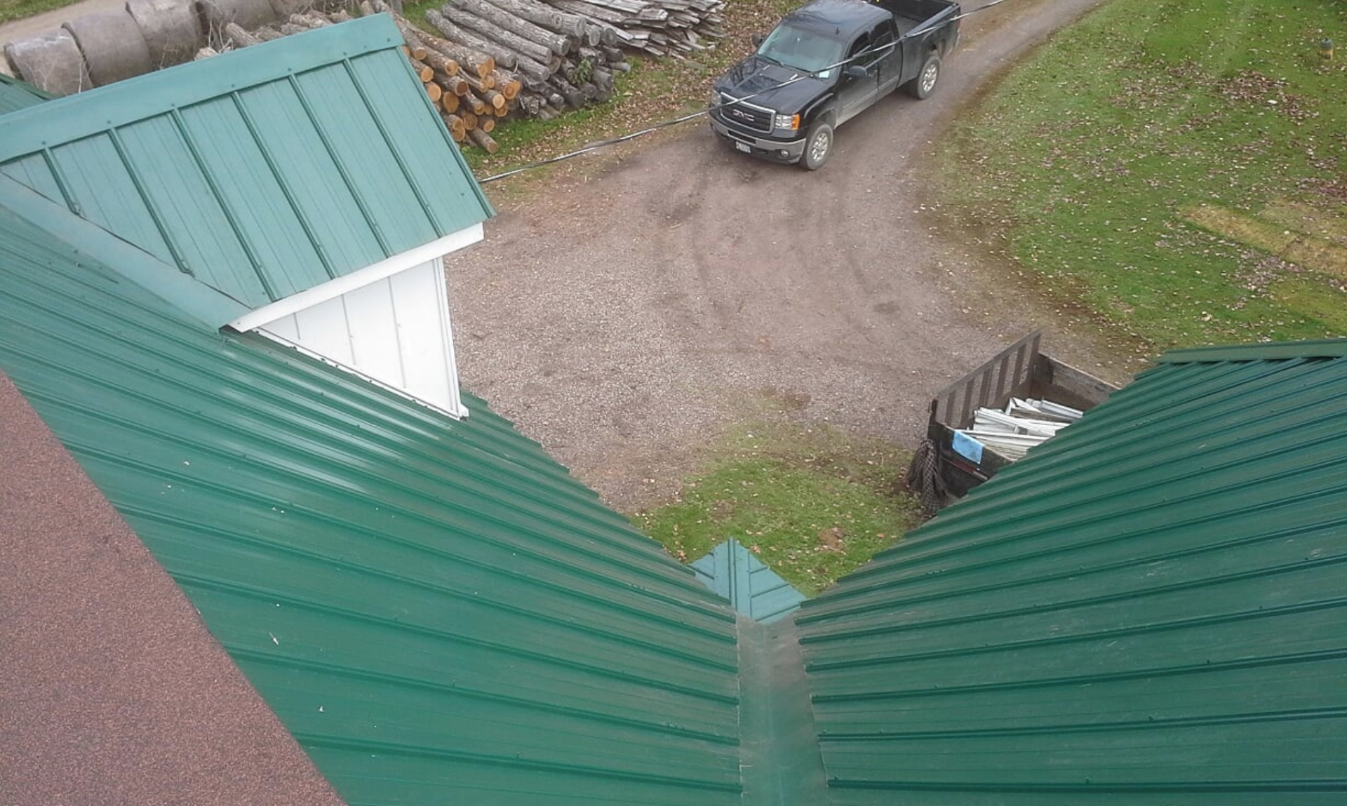 green metal roof with dormer window