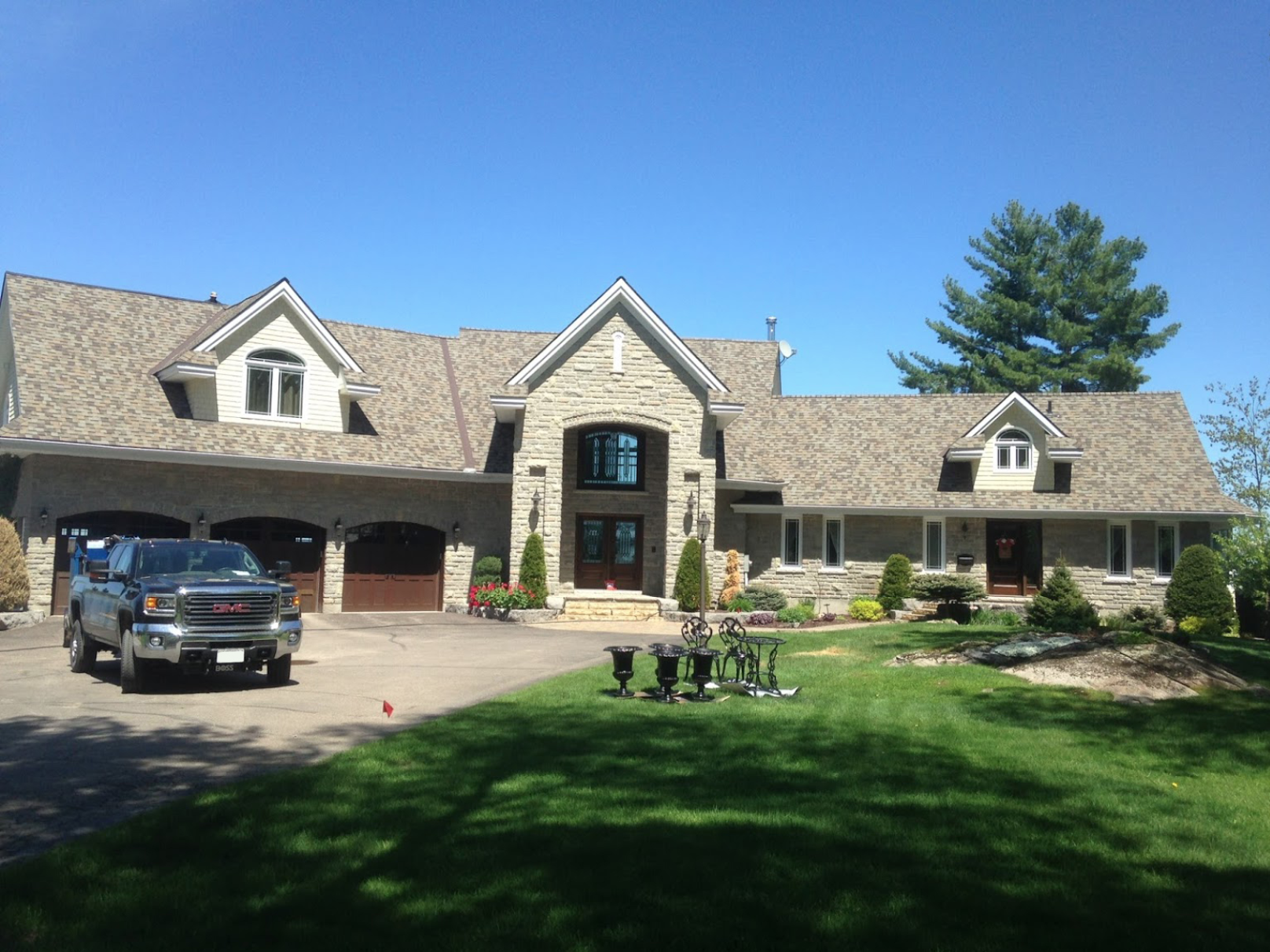 large grey house with grey cross-gabled roof