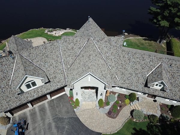 birds eye view of large grey brick house, with cross hipped roof