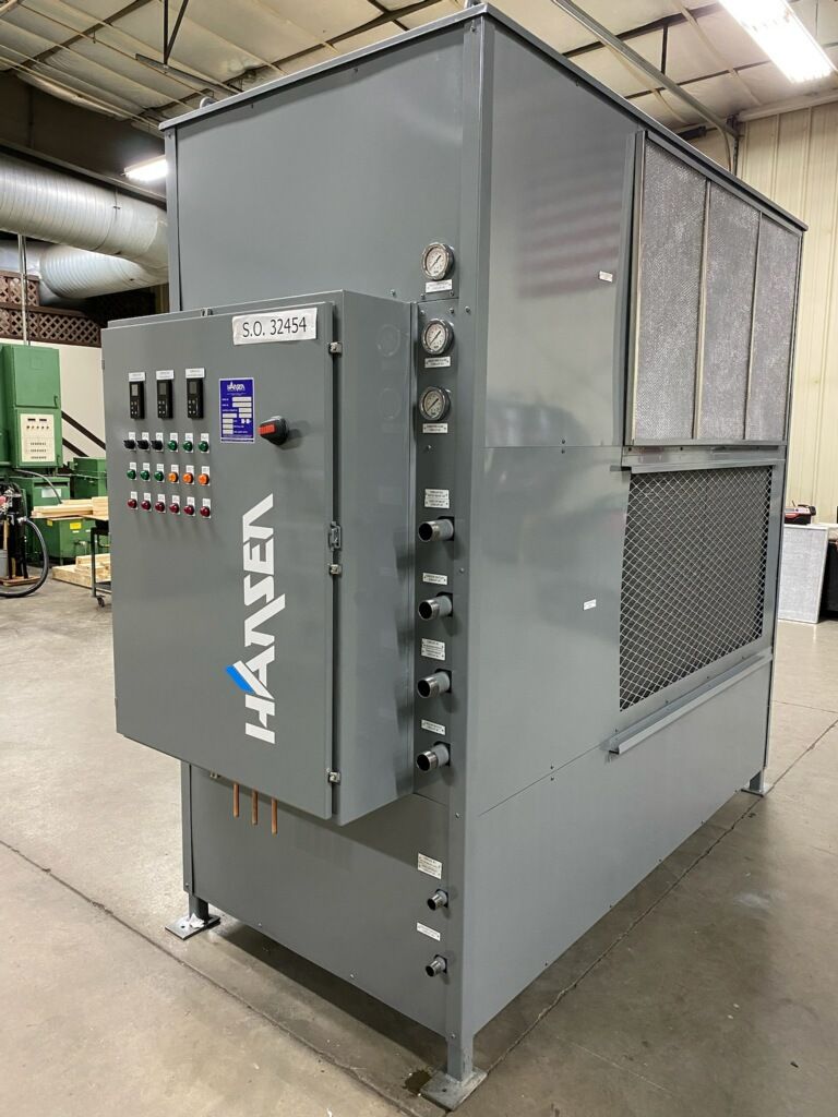 A large gray machine is sitting on the ground in a room.