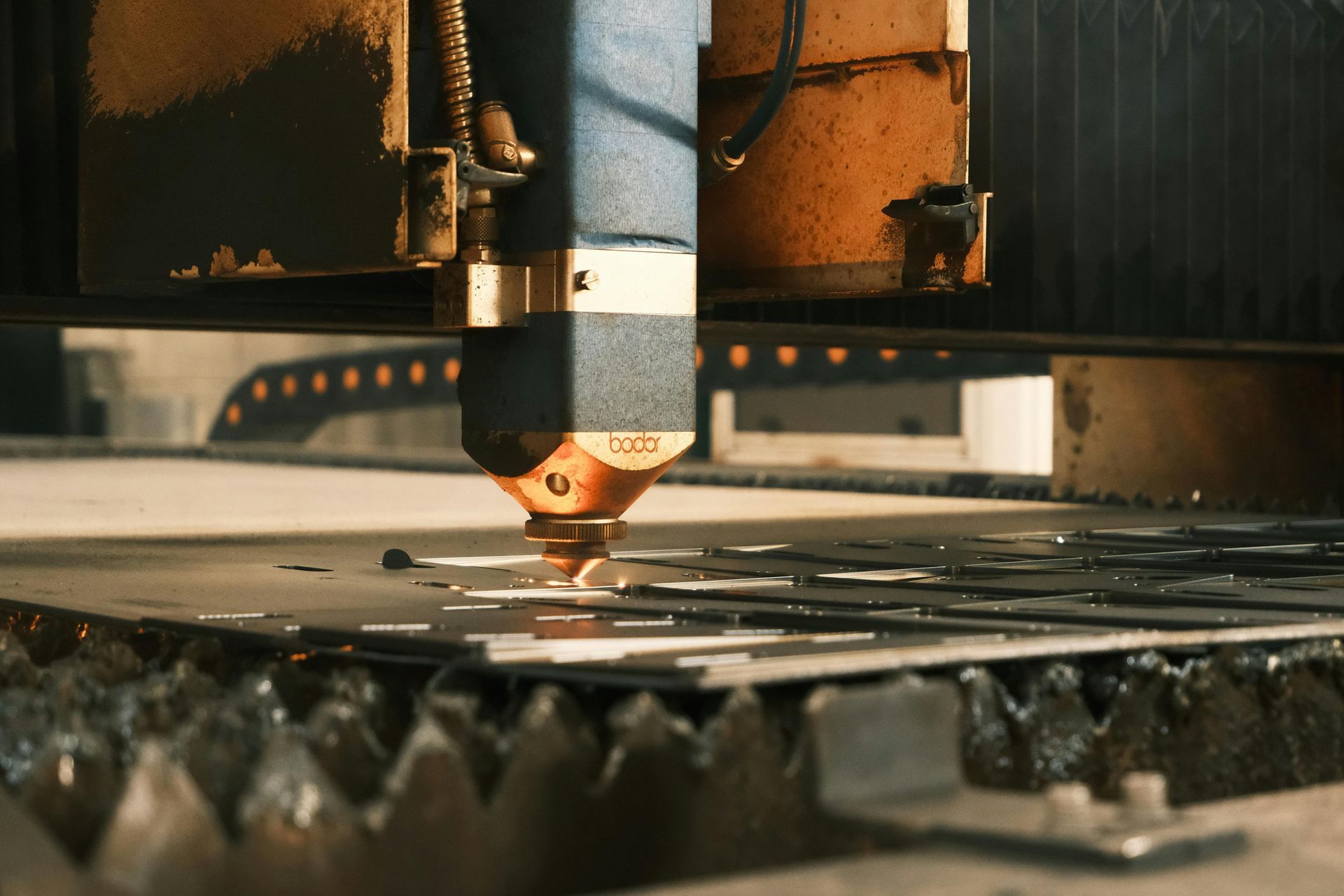 A machine is cutting a piece of metal in a factory.
