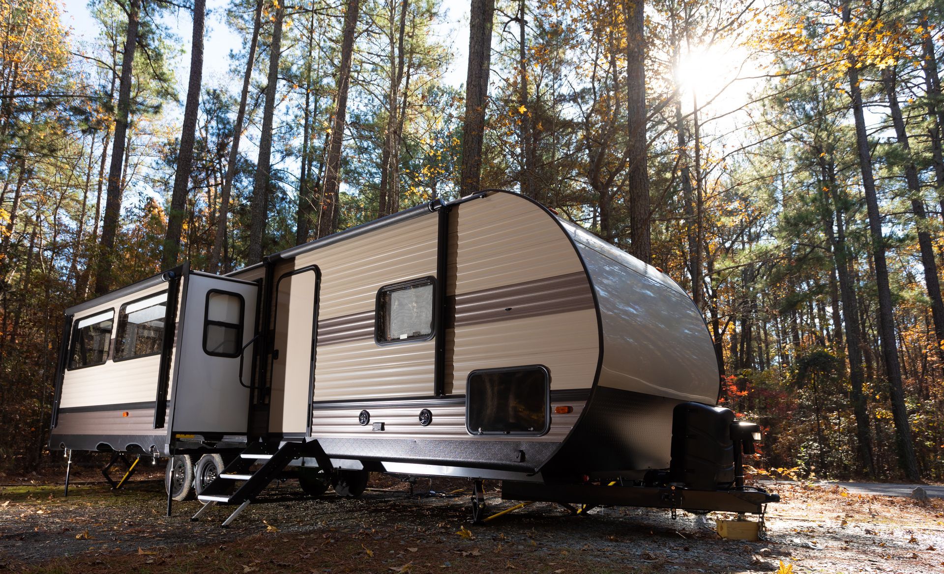 A trailer is parked in the middle of a forest.