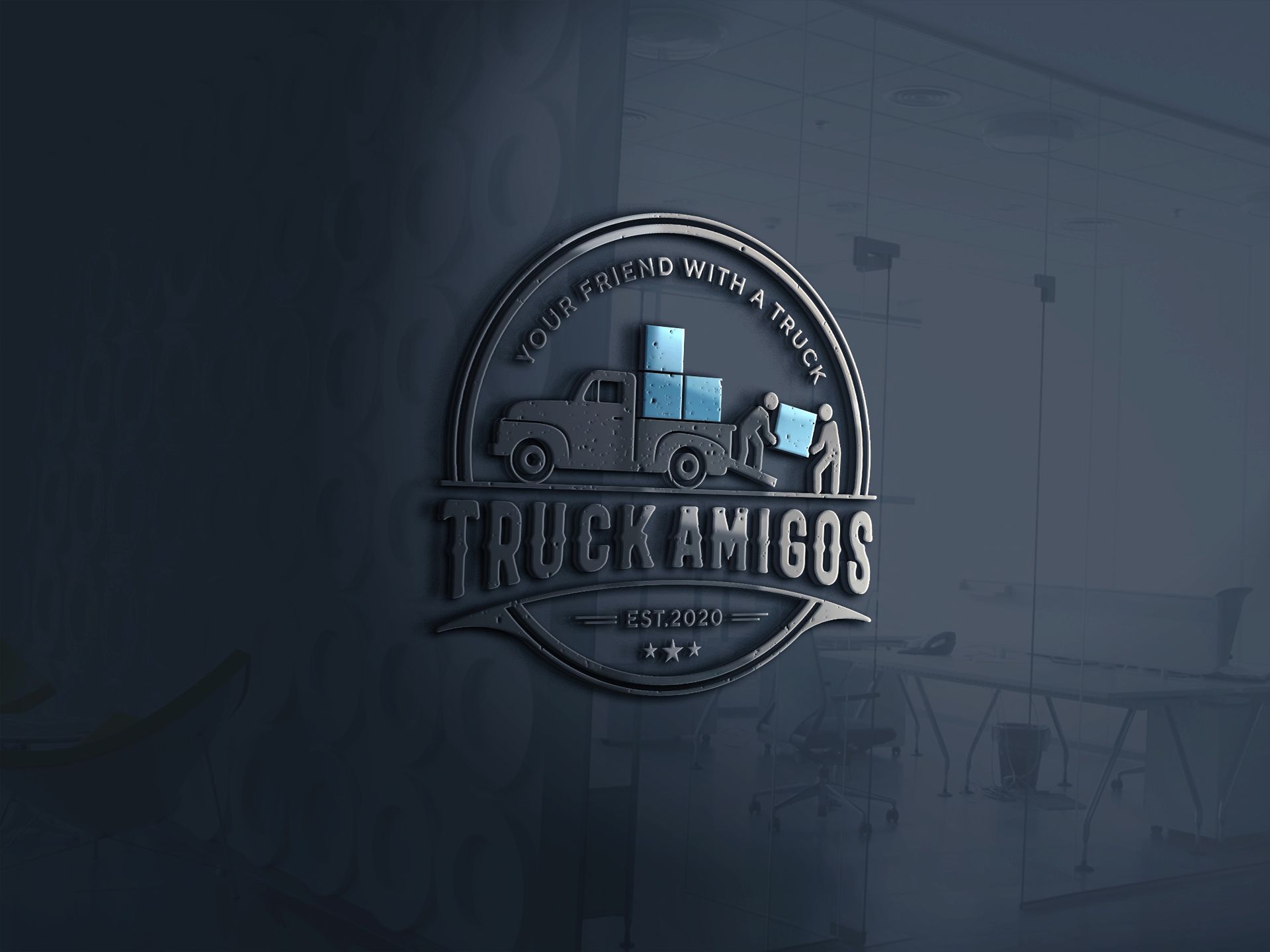 A logo for a company called truck amigos is on a glass wall.