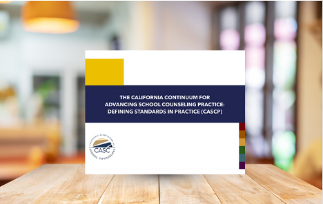 Book cover on a wooden table. Title: California Continuum for Advancing School Counseling Practice.