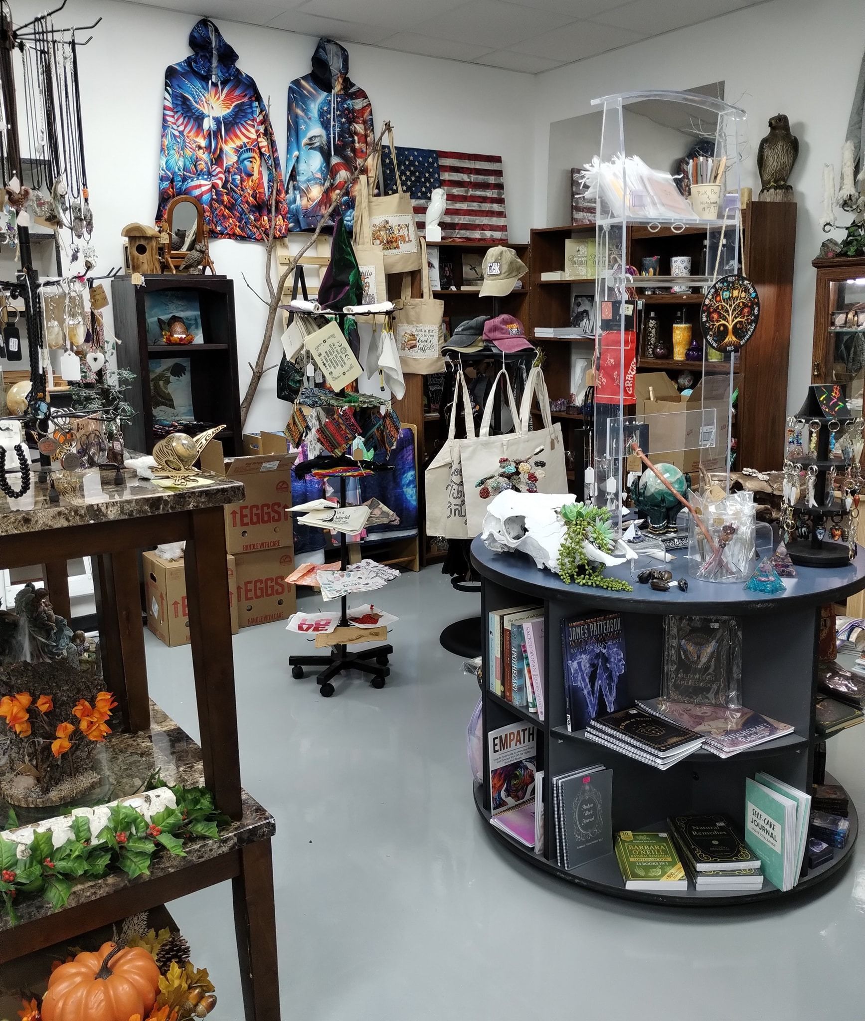 Interior view of a cluttered shop, displaying various merchandise, including clothing, books, and decorative items.