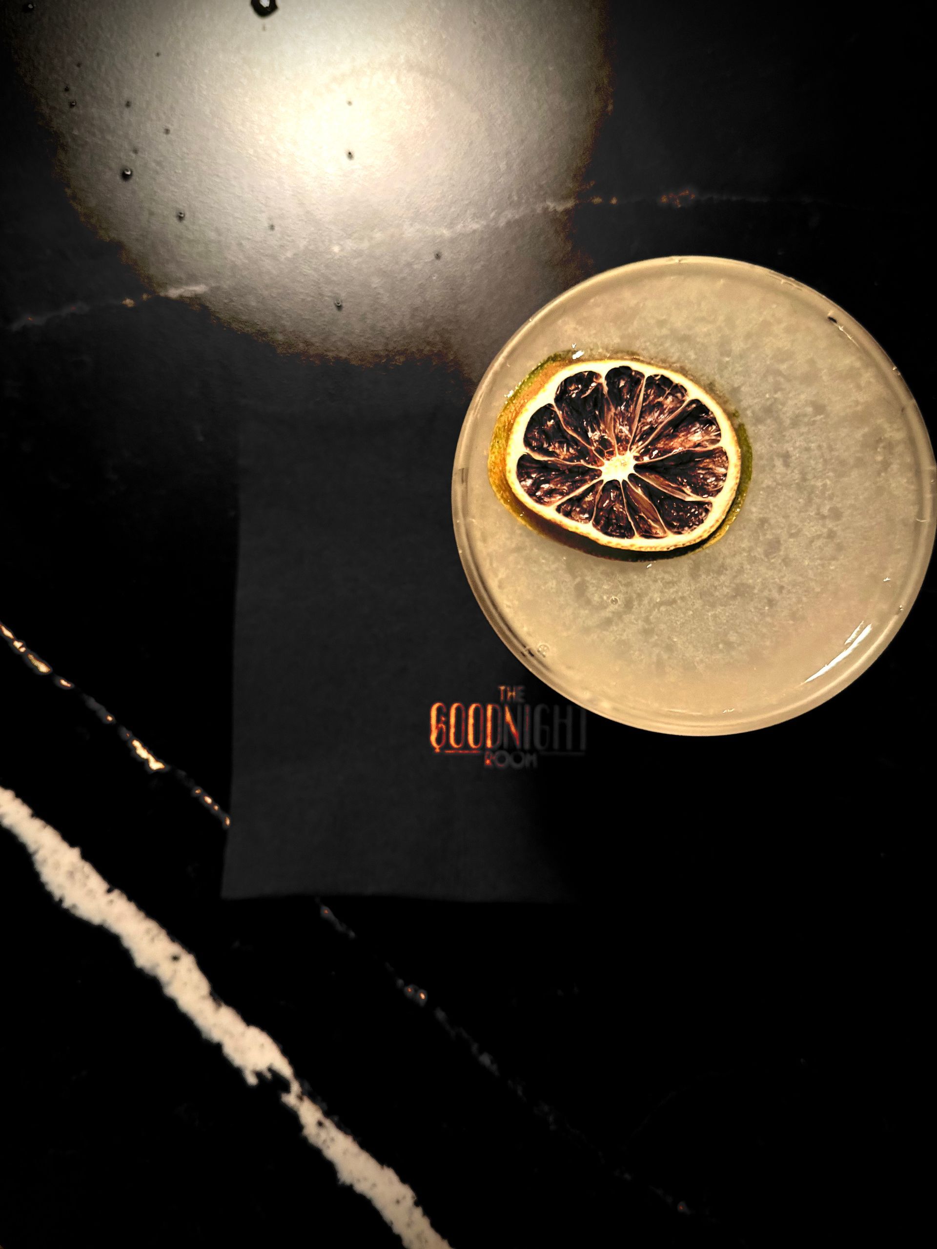 A plate with a slice of orange on top of it