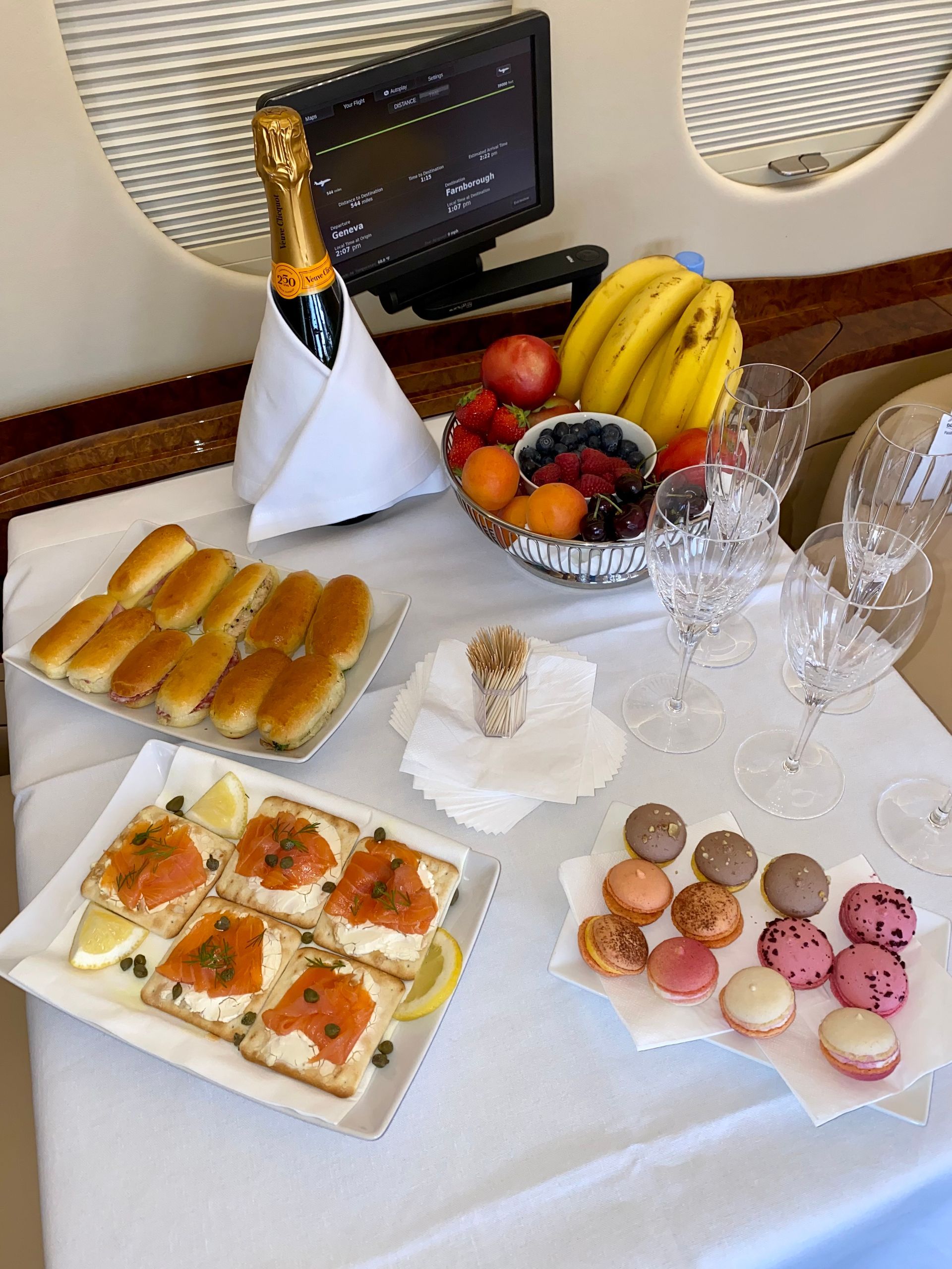 A table topped with plates of food and a bottle of champagne