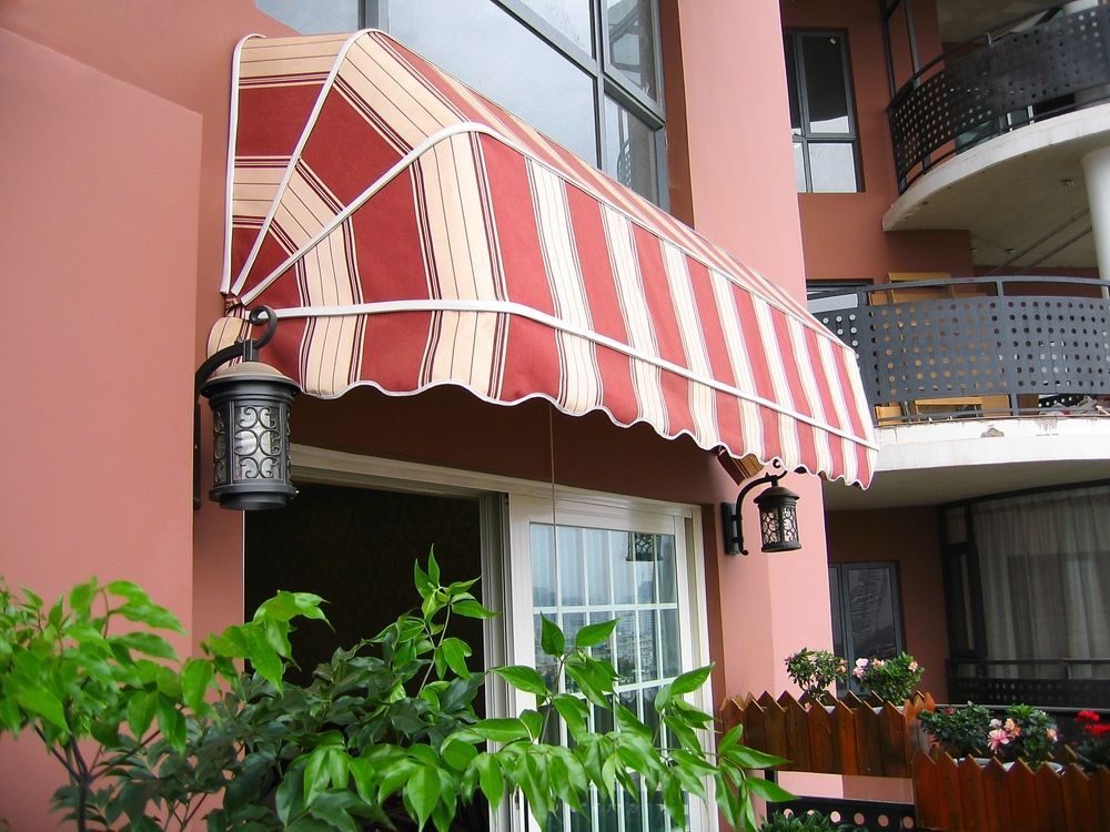 A Red and White Striped Awning Over a Doorway — Simply Smarter Blinds in Tea Gardens, NSW