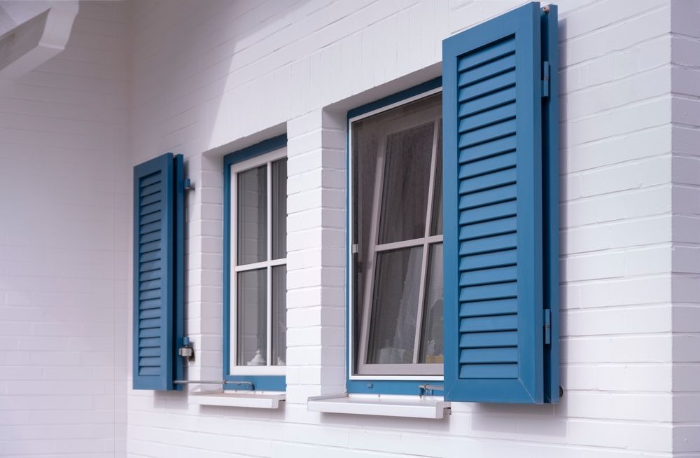 A Gray Building With a Screen on the Side of It — Simply Smarter Blinds in Tea Gardens, NSW