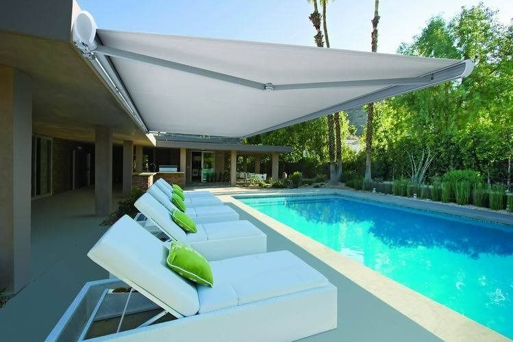 A Row of Lounge Chairs Sitting Next to a Swimming Pool Under an Awning — Simply Smarter Blinds in Tea Gardens, NSW