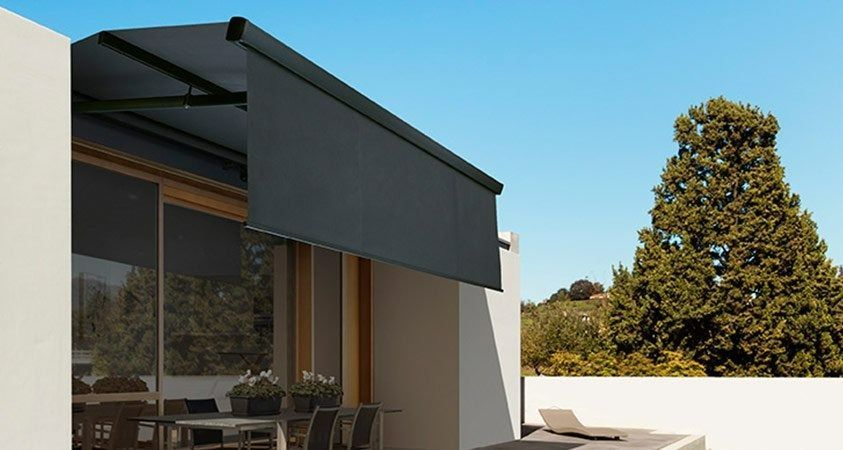 A Patio With a Table and Chairs Under an Awning — Simply Smarter Blinds in Tea Gardens, NSW