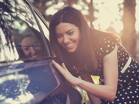 Dent Repair — Client is Happy with Her Shiny Car in Atlanta, GA