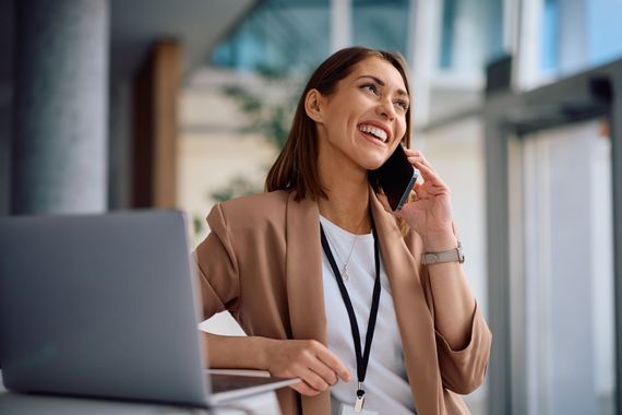 A sandy path leading to the ocean on a sunny day.