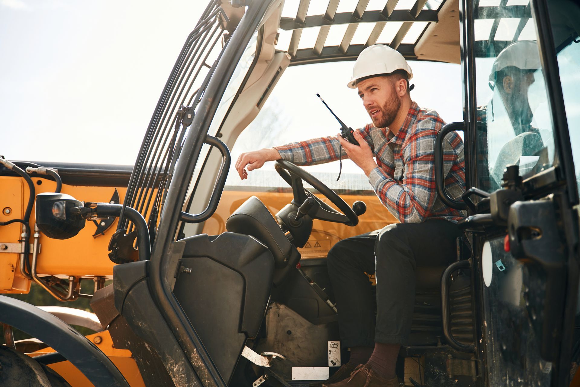 A sandy path leading to the ocean on a sunny day.