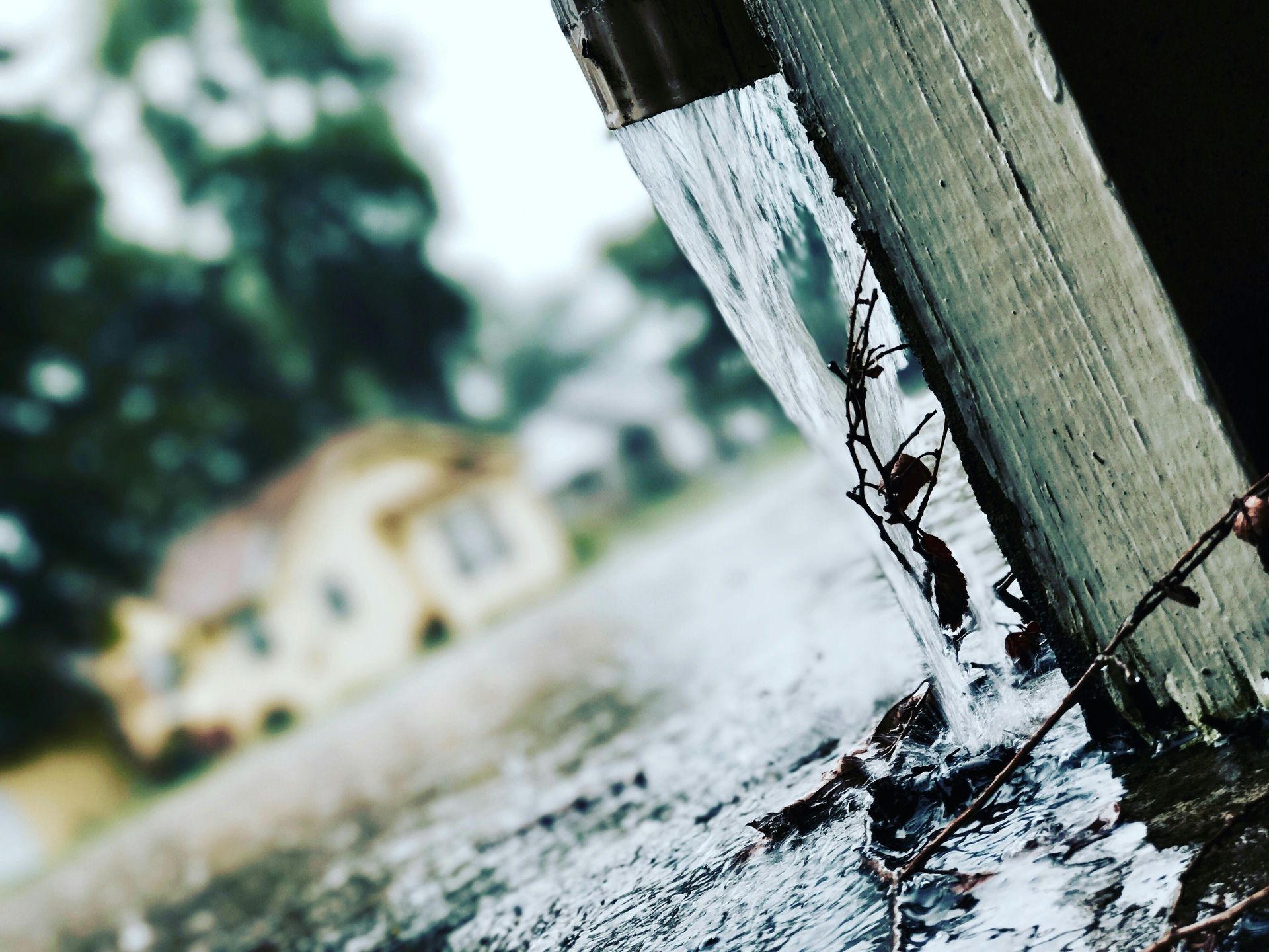 A close up of a fence post with water coming out of it