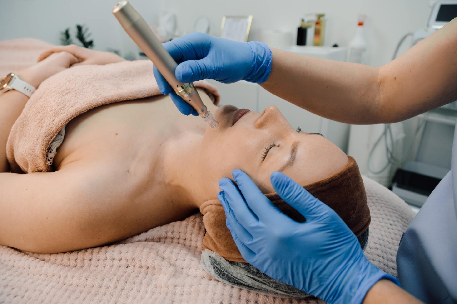 A woman is getting a facial treatment in a beauty salon.