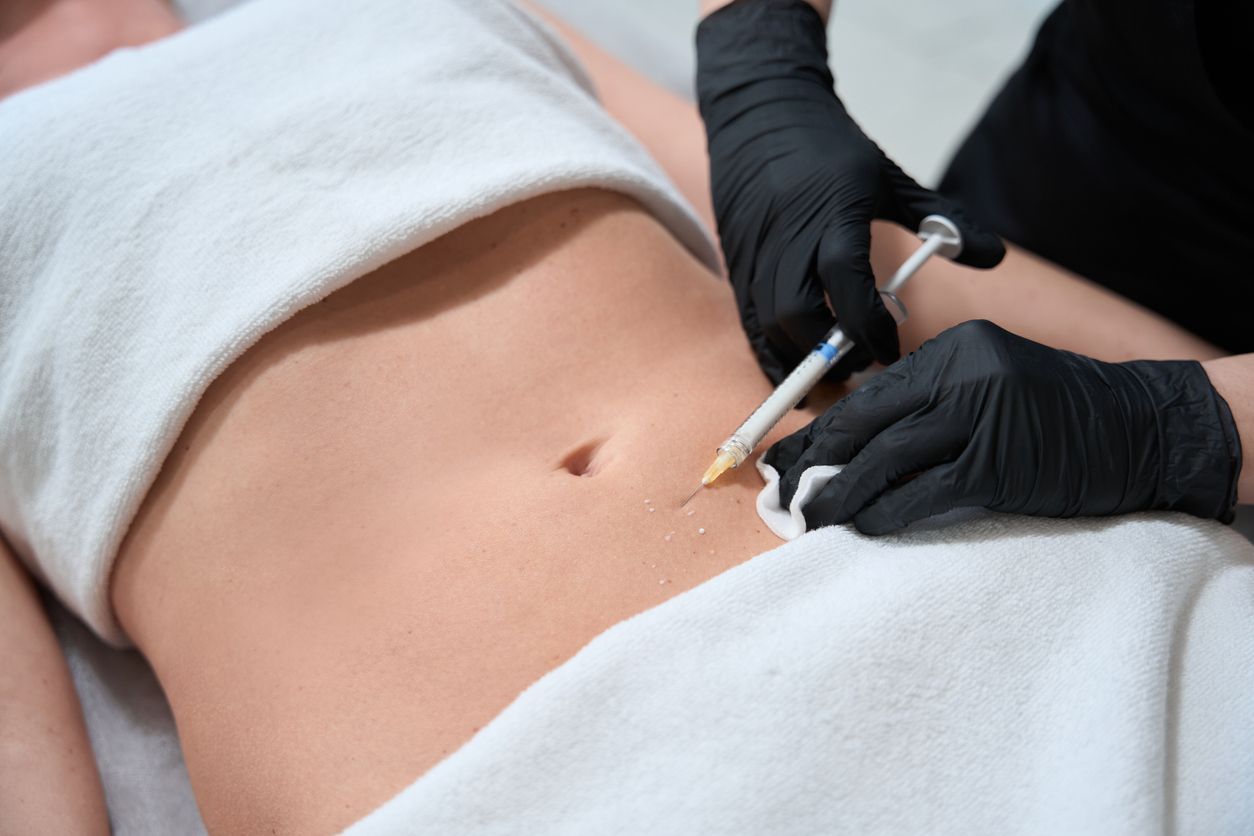 A woman is getting a botox injection in her neck.