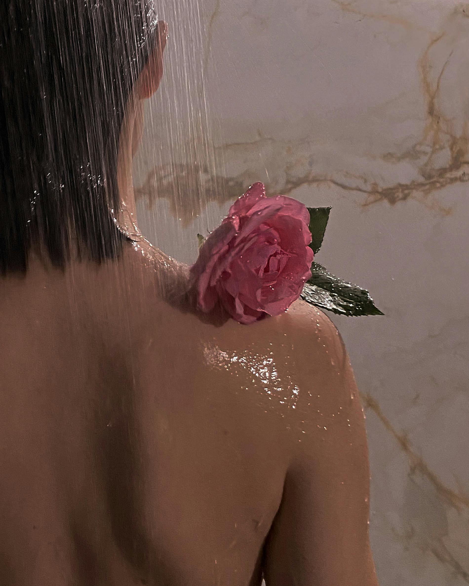 woman with wet hair and a rose