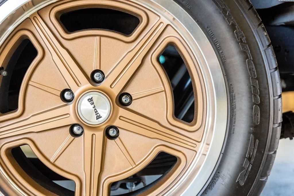 A close up of a car wheel with a tire on it