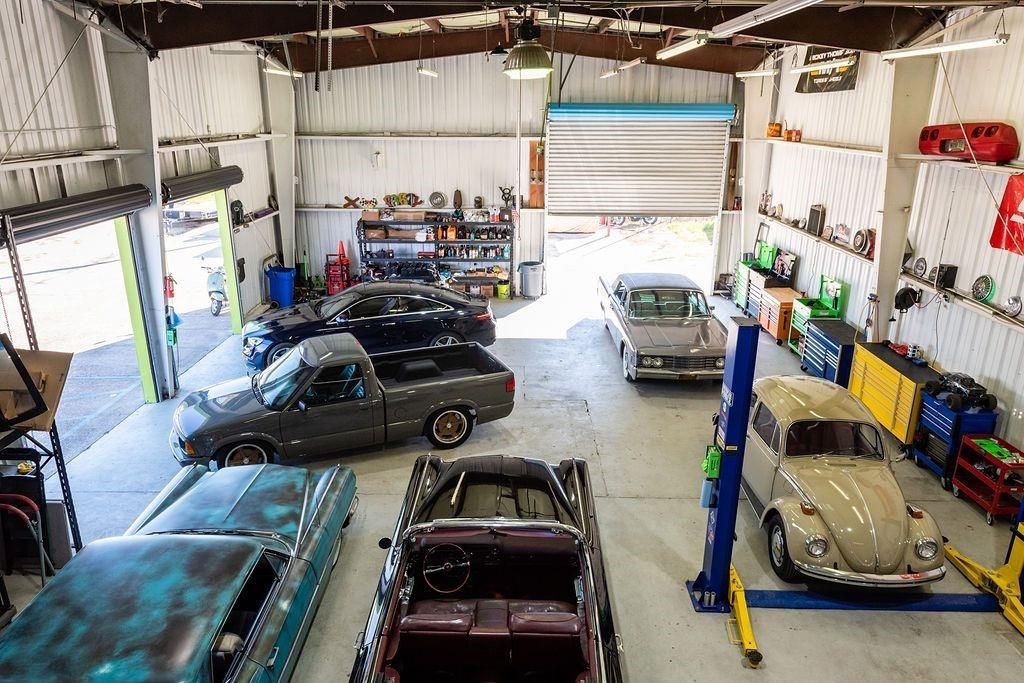 A bunch of cars are parked in a garage.
