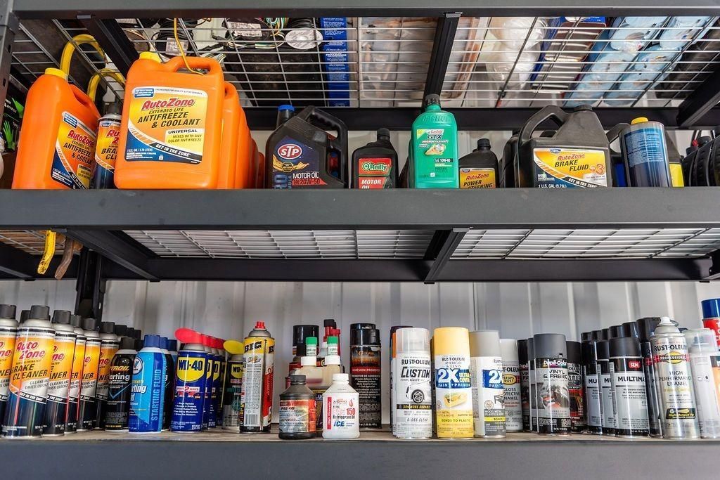 A shelf filled with lots of different types of chemicals.