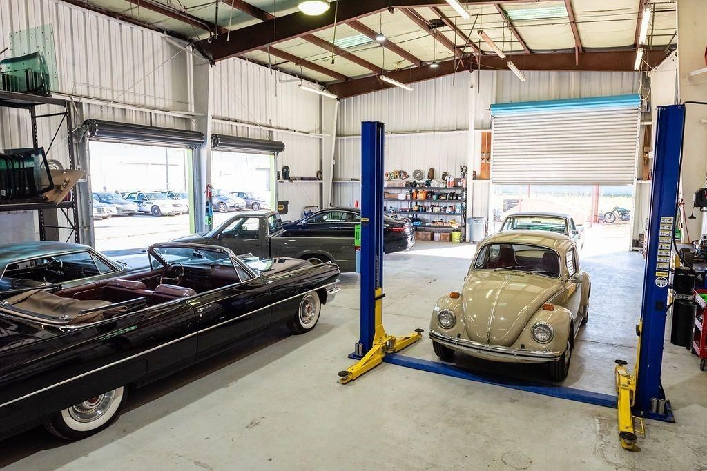 A car is sitting on a lift in a garage.