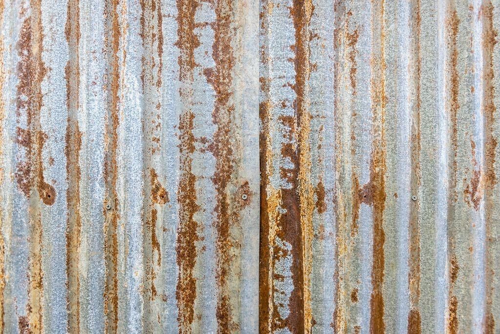 A close up of a rusty corrugated metal wall.