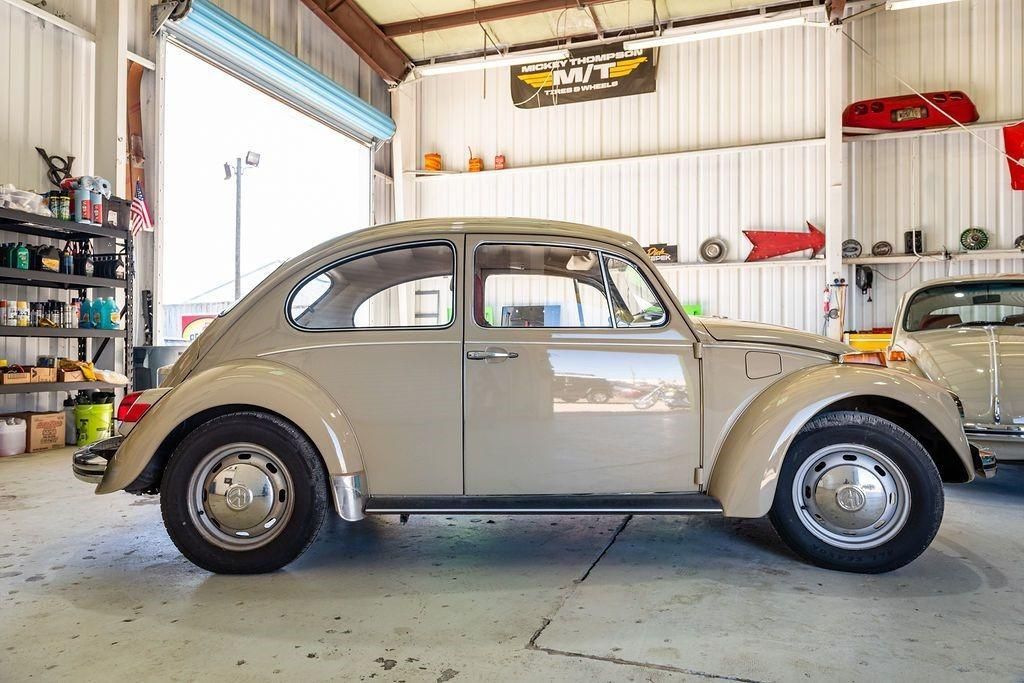 A volkswagen beetle is parked in a garage.