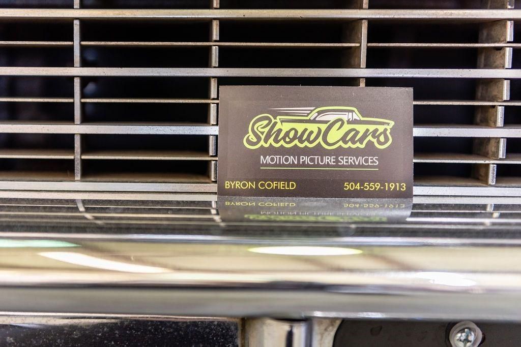 A business card for show cars is on the front of a car