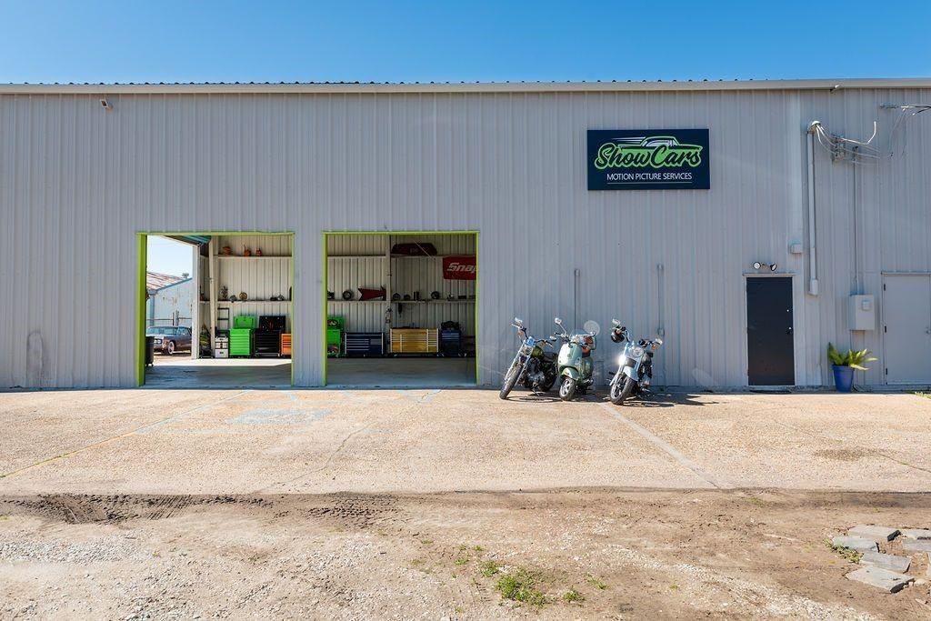 Two motorcycles are parked in front of a building.