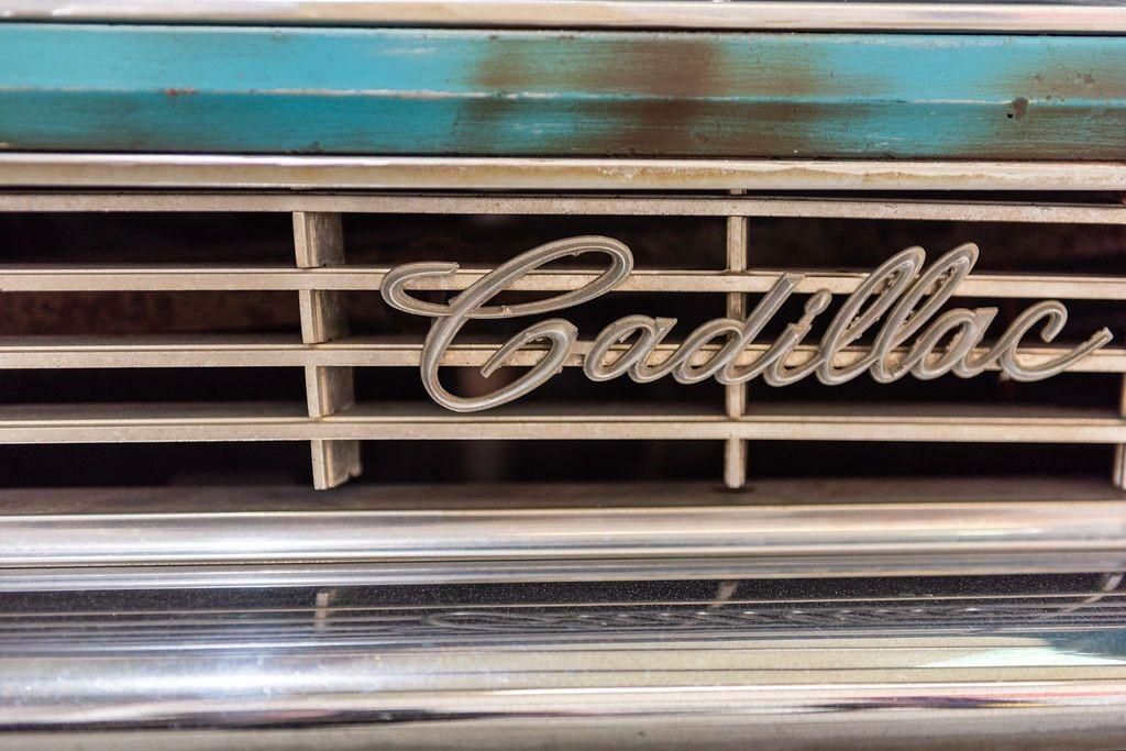A close up of a cadillac grille with the word cadillac on it.