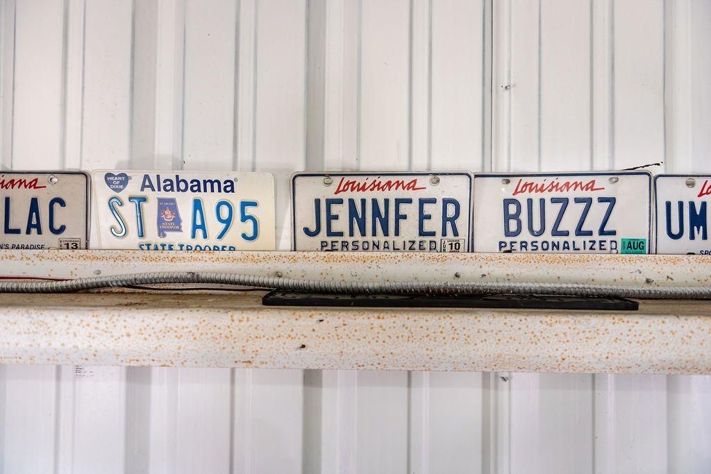 A row of alabama license plates hanging on a wall